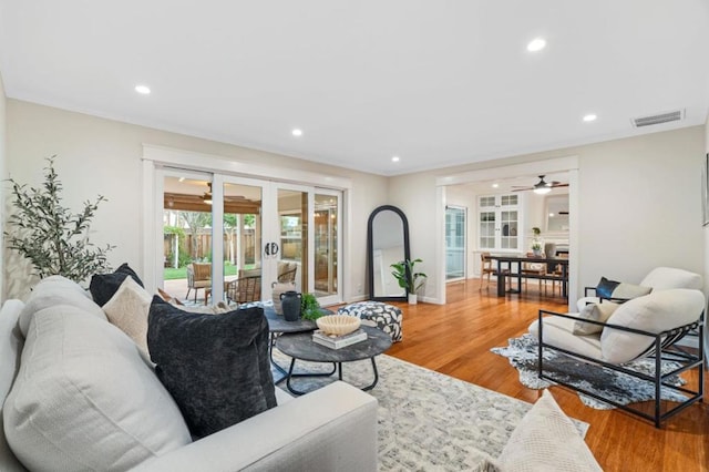 living room featuring hardwood / wood-style floors, ceiling fan, and french doors