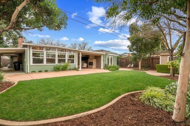 rear view of property with a yard and a patio area