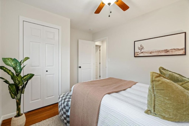 bedroom with wood-type flooring, ceiling fan, and a closet