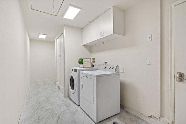 laundry area featuring washer and clothes dryer and cabinets