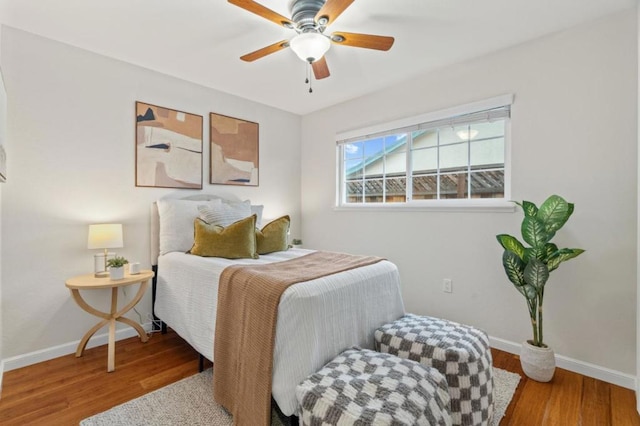 bedroom with hardwood / wood-style flooring and ceiling fan