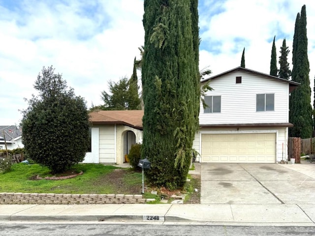 view of front of house with a garage and a front lawn