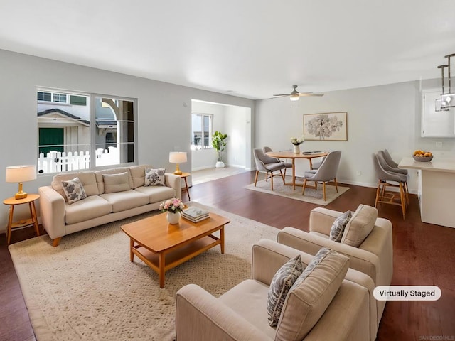 living room with ceiling fan and dark hardwood / wood-style flooring