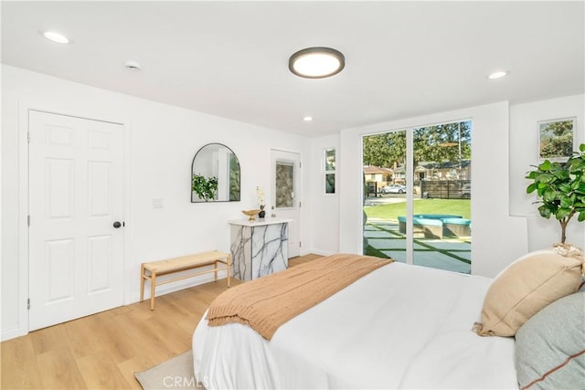 bedroom with access to exterior and light hardwood / wood-style floors