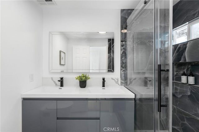 bathroom featuring walk in shower and vanity