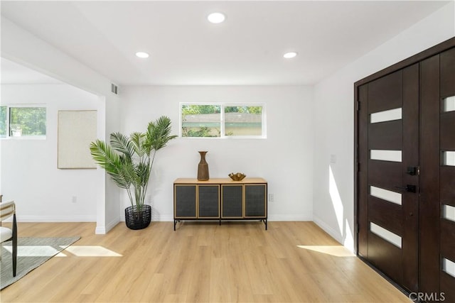 foyer entrance with plenty of natural light and light hardwood / wood-style flooring