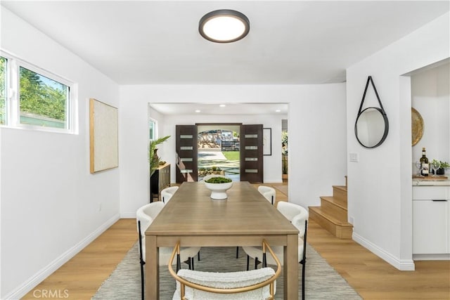 dining space featuring light wood-type flooring