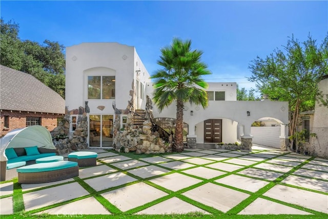 back of property featuring french doors and a patio area