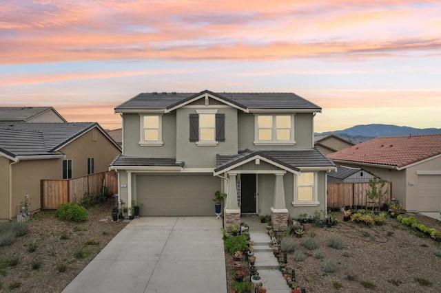 view of front of property featuring a garage and a mountain view