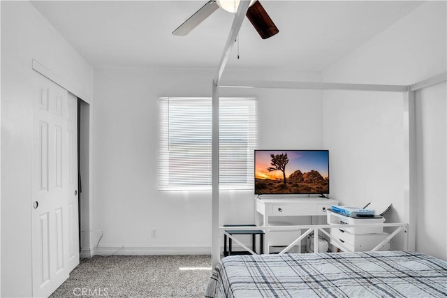 carpeted bedroom featuring ceiling fan and a closet