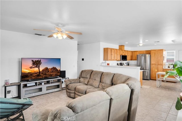 tiled living room featuring ceiling fan