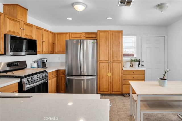 kitchen featuring appliances with stainless steel finishes and light tile patterned floors