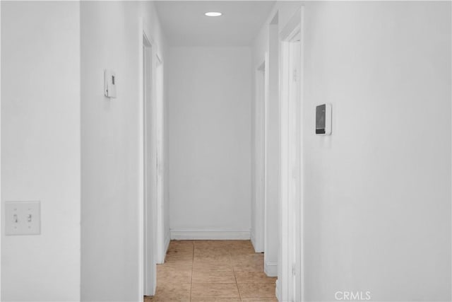 hall featuring light tile patterned floors