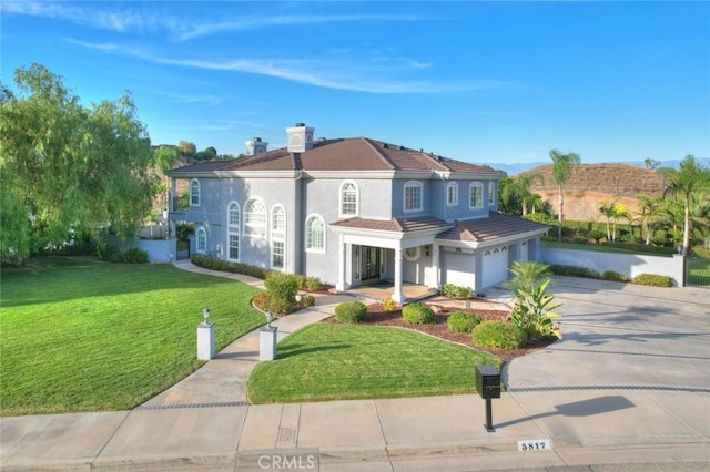 view of front of house featuring a garage and a front lawn