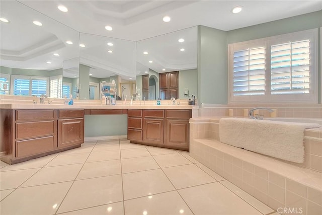 bathroom featuring vanity, tile patterned floors, and tiled bath