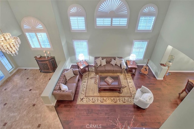 living room featuring hardwood / wood-style flooring and a towering ceiling