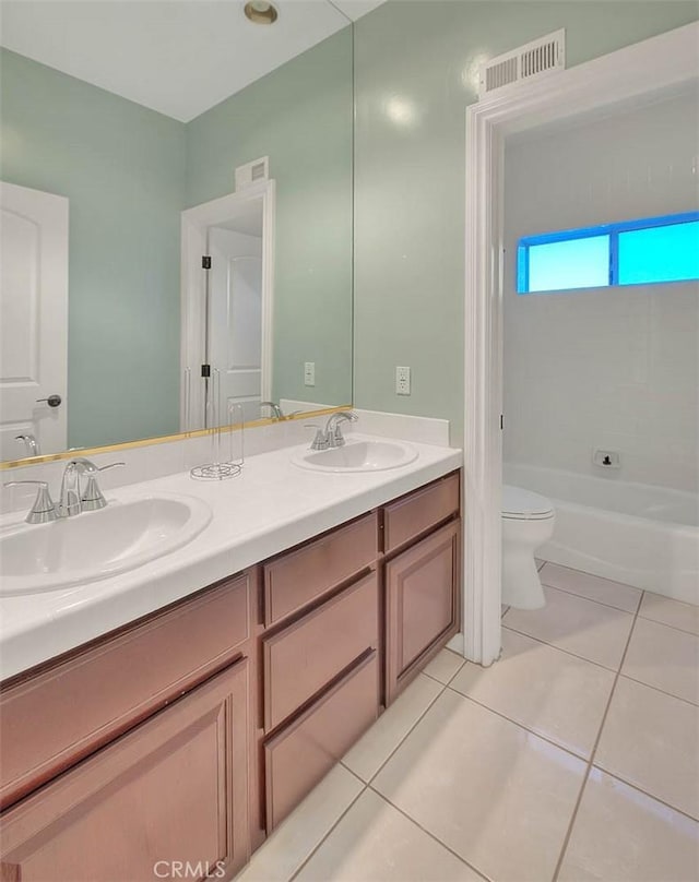 bathroom with vanity, tile patterned floors, and toilet