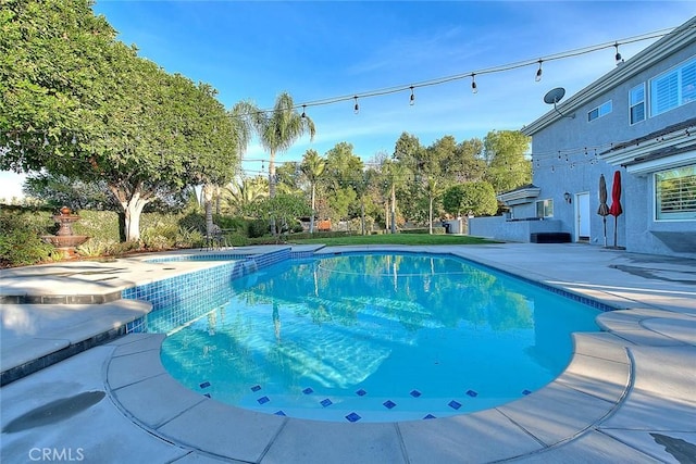 view of swimming pool featuring a patio area