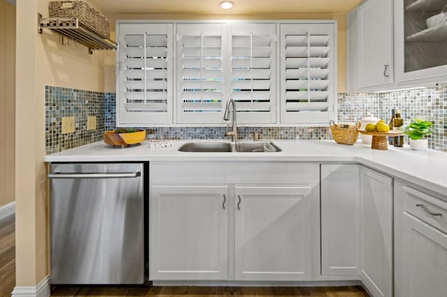 kitchen featuring sink, decorative backsplash, stainless steel dishwasher, and white cabinets