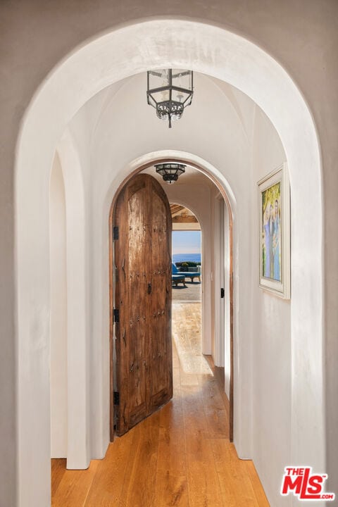 corridor featuring hardwood / wood-style floors