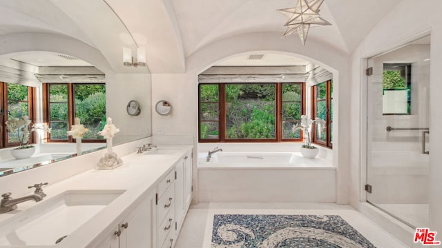 bathroom with lofted ceiling, separate shower and tub, tile patterned flooring, and vanity