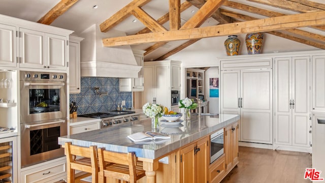 kitchen featuring white cabinetry, appliances with stainless steel finishes, and a center island