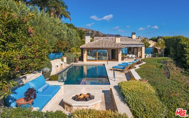 view of swimming pool featuring a gazebo, an outdoor living space with a fire pit, and a patio