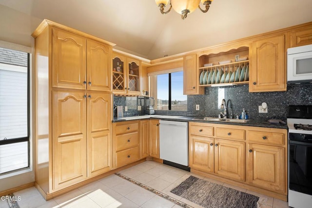 kitchen with vaulted ceiling, tasteful backsplash, sink, light tile patterned floors, and white appliances