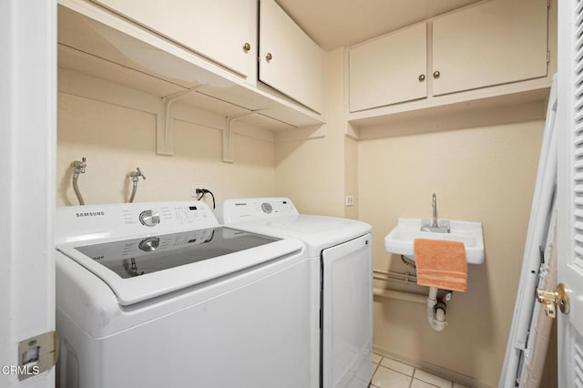 1121 E Wilson Ave Unit 12, Glendale, CA 91206 - laundry room with independent washer and dryer, cabinet space, and light tile patterned floors