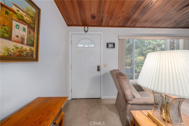 carpeted entryway with wood ceiling