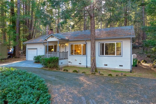 single story home with a garage and covered porch