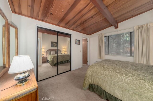 bedroom with lofted ceiling with beams, light colored carpet, a closet, and wooden ceiling