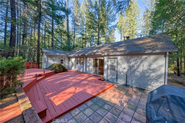 wooden terrace featuring area for grilling and a patio