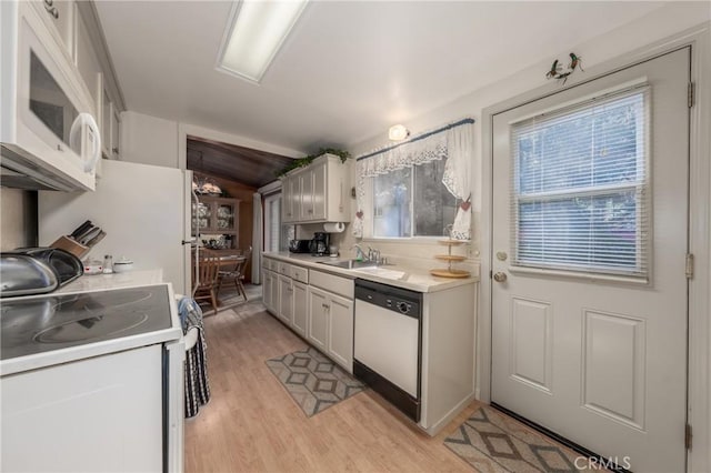 kitchen featuring white cabinetry, sink, white appliances, and plenty of natural light