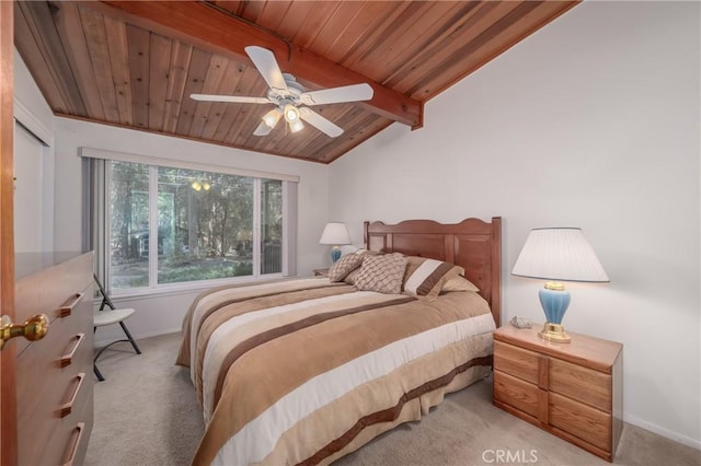 carpeted bedroom featuring ceiling fan, vaulted ceiling with beams, and wood ceiling