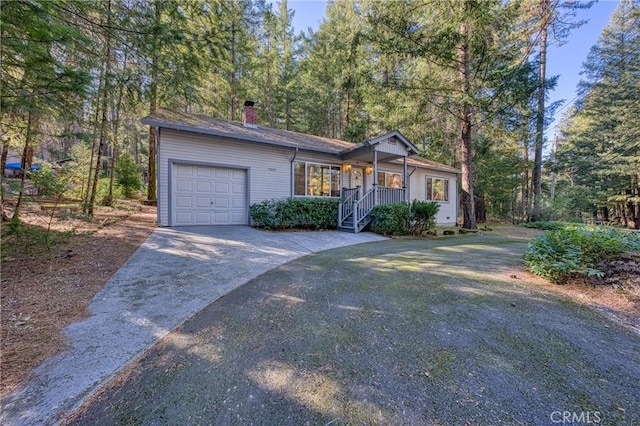 view of front facade with a garage and covered porch