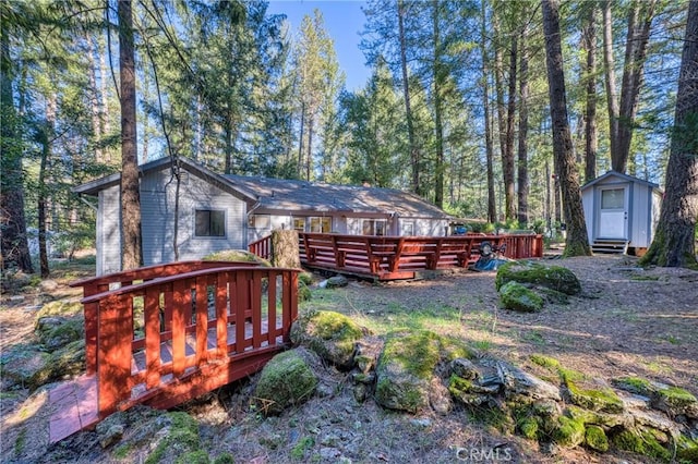 view of yard featuring a storage shed and a deck