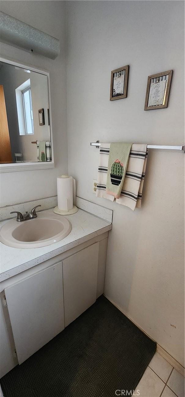 bathroom with tile patterned floors and vanity