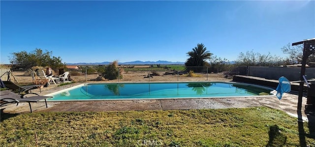 view of pool with a mountain view and a patio area