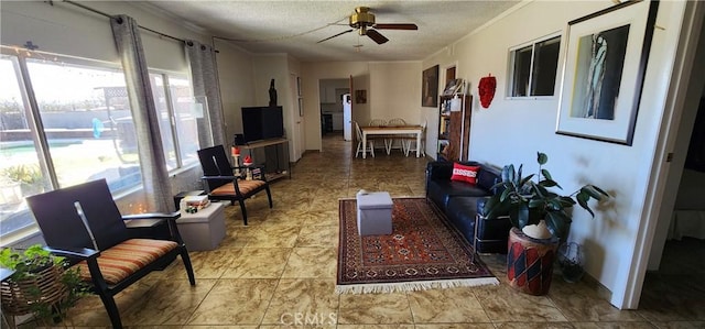 living room featuring a textured ceiling and ceiling fan