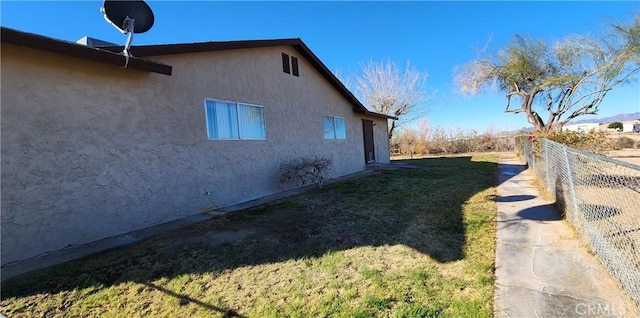 view of property exterior with a yard