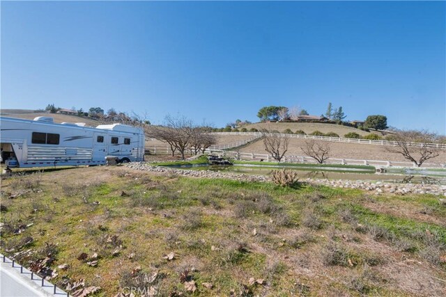 view of yard with a rural view