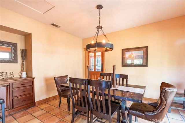 tiled dining room with a healthy amount of sunlight