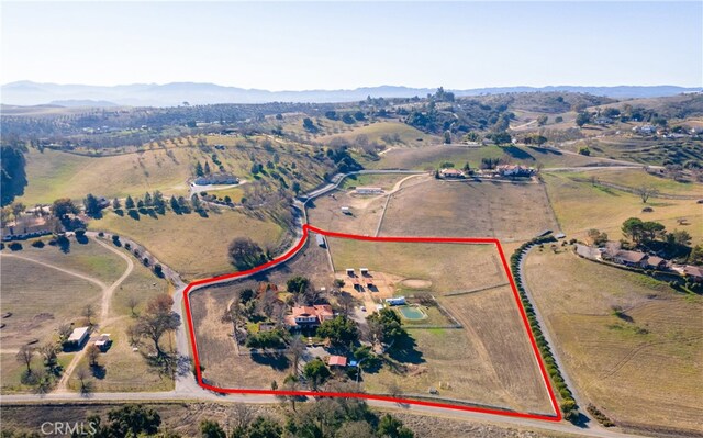 drone / aerial view featuring a mountain view and a rural view