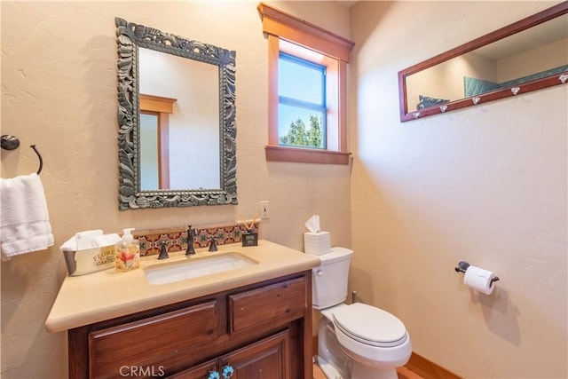 bathroom featuring vanity and toilet