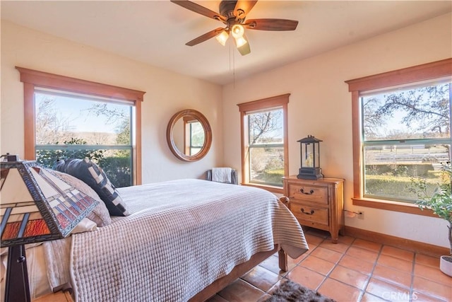 tiled bedroom with ceiling fan