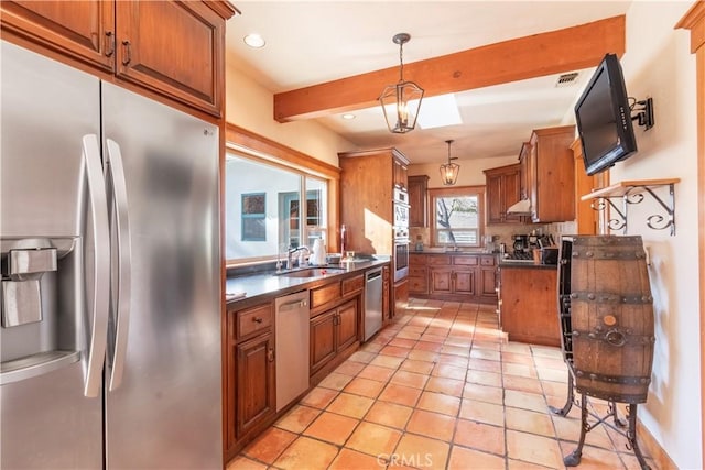 kitchen featuring pendant lighting, sink, appliances with stainless steel finishes, light tile patterned flooring, and beamed ceiling