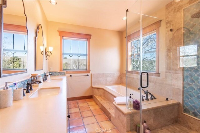 bathroom featuring tile patterned flooring, vanity, separate shower and tub, and a wealth of natural light