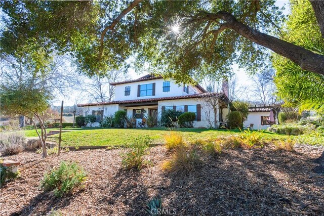 mediterranean / spanish house with a front lawn