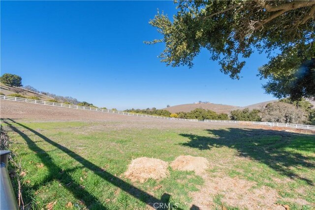 view of yard featuring a mountain view and a rural view